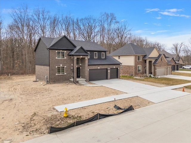 view of front of house featuring brick siding, driveway, and an attached garage