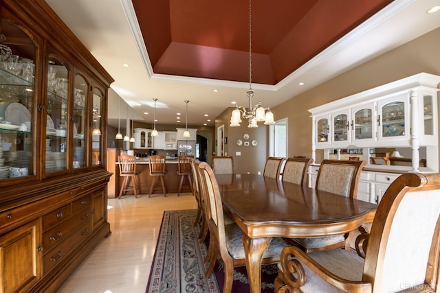 dining area featuring a raised ceiling, light wood finished floors, a notable chandelier, and recessed lighting