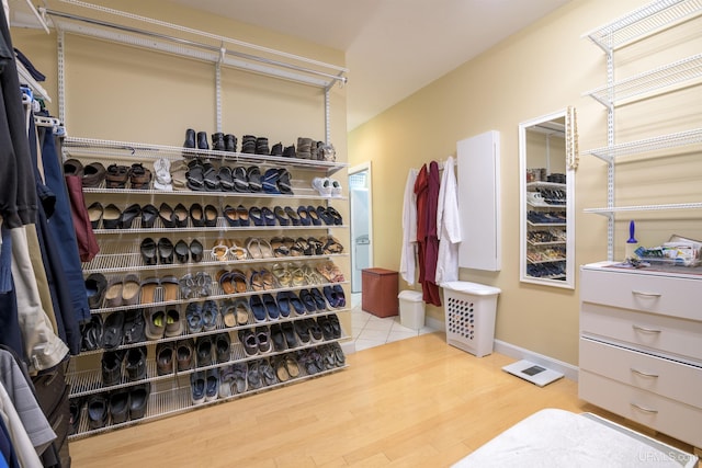 walk in closet with wood finished floors