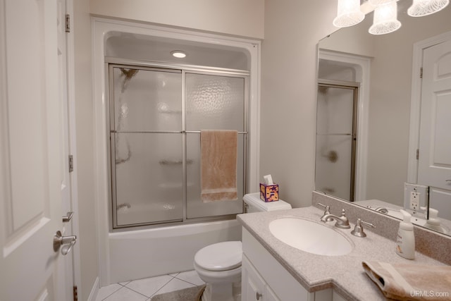 full bathroom featuring toilet, shower / bath combination with glass door, vanity, and tile patterned flooring