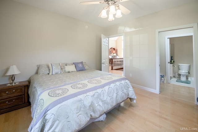bedroom with ensuite bathroom, baseboards, light wood-type flooring, and a ceiling fan