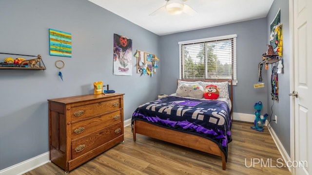 bedroom featuring baseboards, a ceiling fan, and wood finished floors
