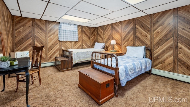 bedroom with a paneled ceiling, a baseboard radiator, and carpet floors