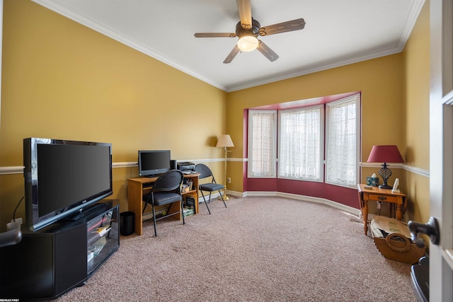 carpeted home office featuring baseboards, crown molding, and a ceiling fan