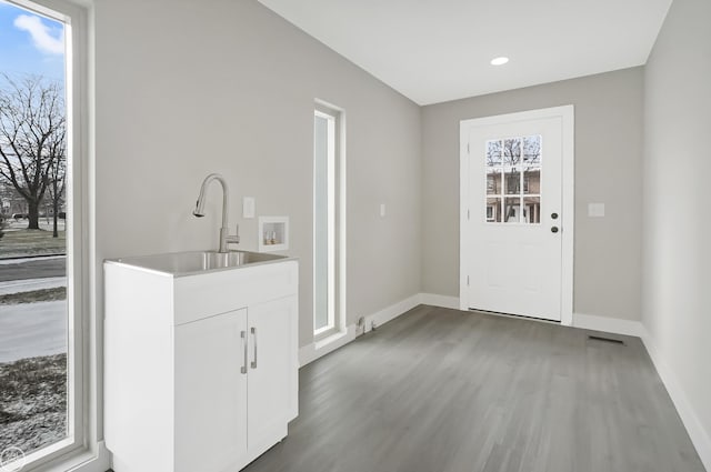 interior space with baseboards, wood finished floors, visible vents, and recessed lighting