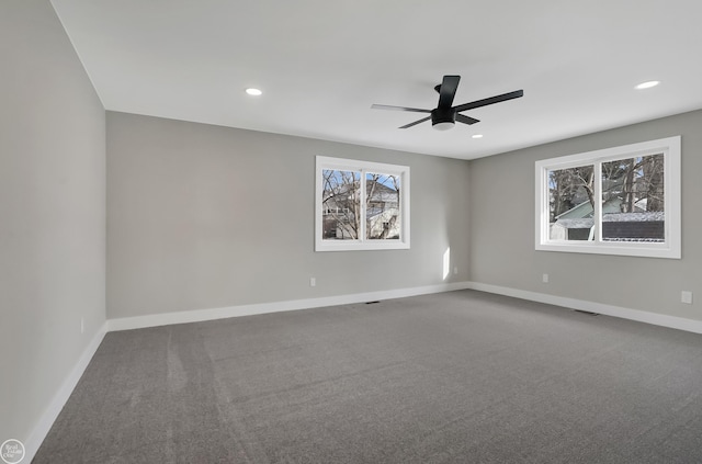 carpeted spare room with visible vents, a ceiling fan, baseboards, and recessed lighting