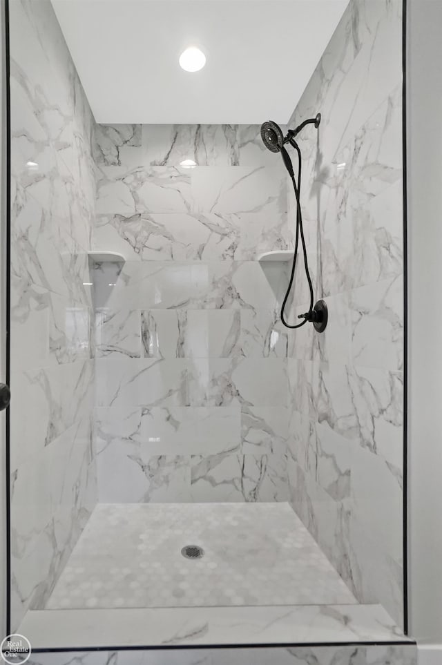 bathroom with a marble finish shower