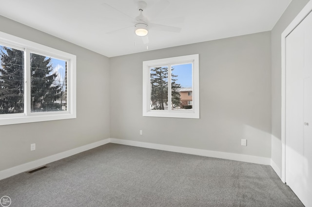 empty room featuring baseboards, carpet, and ceiling fan