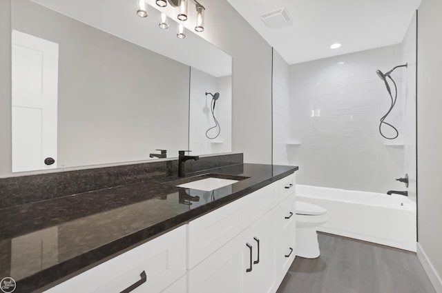 full bath with wood finished floors, visible vents, toilet, vanity, and shower / tub combination
