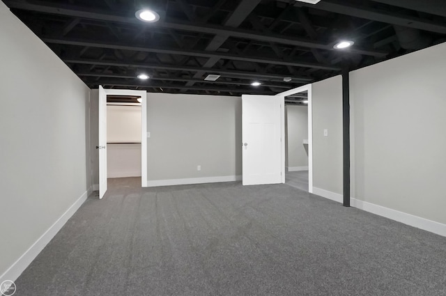 finished basement featuring baseboards and carpet