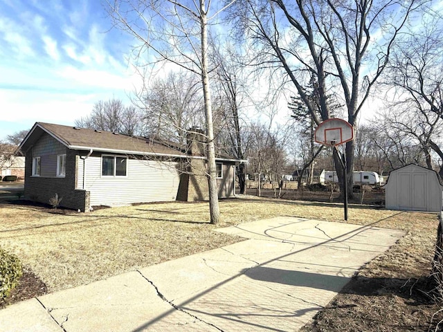exterior space with a lawn and a shed