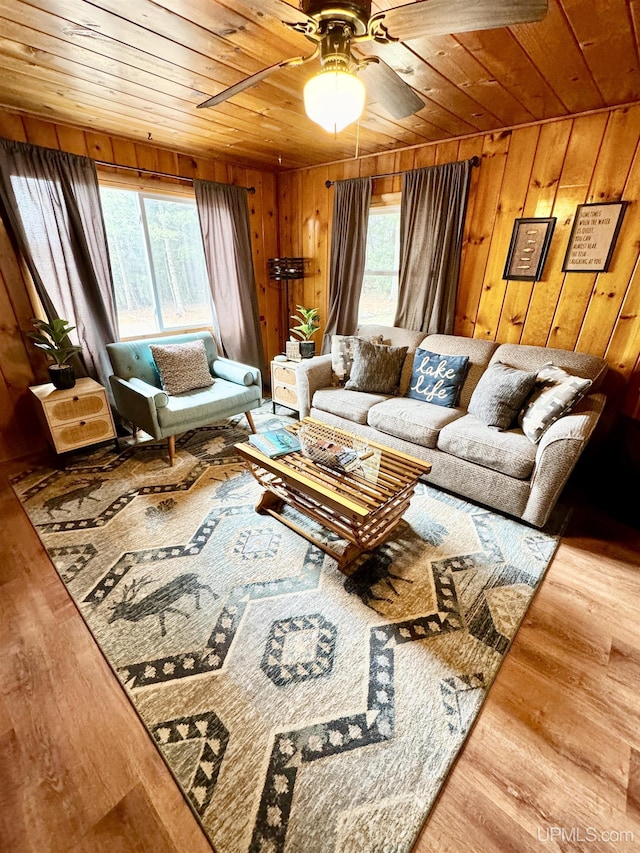 living room with wood walls, wood finished floors, and wood ceiling