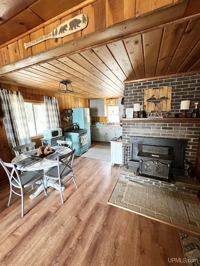 living room featuring wooden ceiling, wood finished floors, and a fireplace