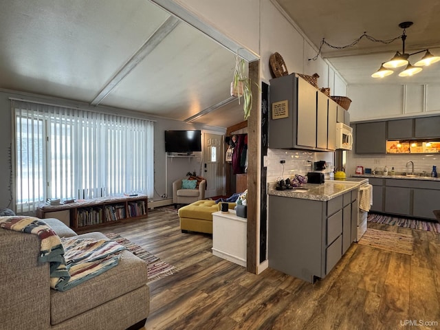 9260 S US Highway 41, Skandia, MI 49885 - kitchen with white microwave, dark wood-style flooring, a sink, open floor plan, and gray cabinetry