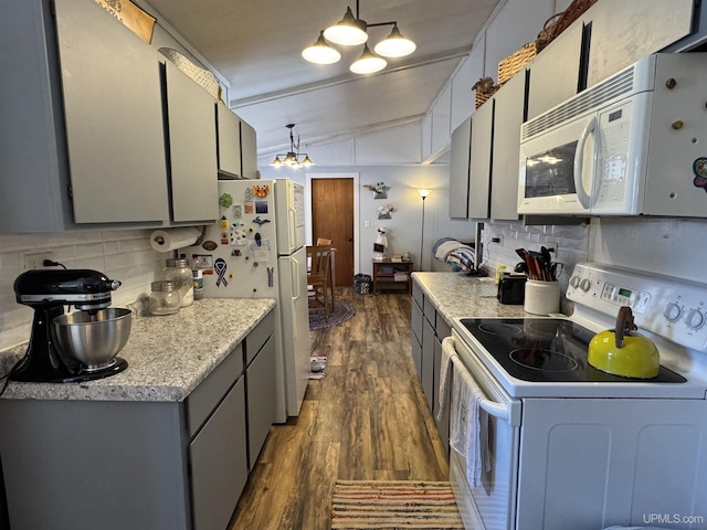 9260 S US Highway 41, Skandia, MI 49885 - kitchen featuring a chandelier, white appliances, dark wood-style floors, light countertops, and backsplash
