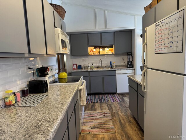 9260 S US Highway 41, Skandia, MI 49885 - kitchen with tasteful backsplash, a sink, white appliances, dark wood-type flooring, and gray cabinets