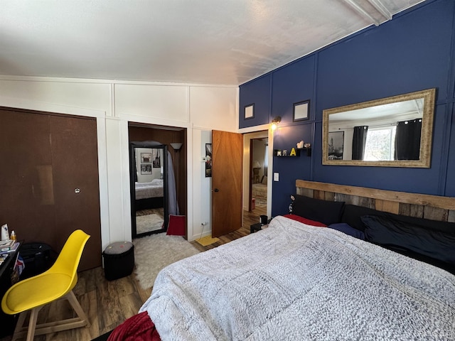 9260 S US Highway 41, Skandia, MI 49885 - bedroom featuring a decorative wall, a closet, and wood finished floors