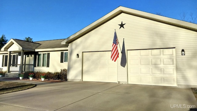 view of home's exterior featuring concrete driveway and a garage