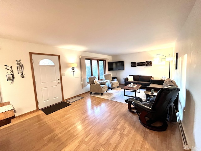 living room featuring light wood-type flooring and baseboards