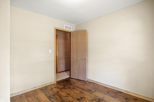 475 S Bartlett Rd, Saint Clair, MI 48079 - empty room with visible vents, baseboards, and dark wood-style flooring