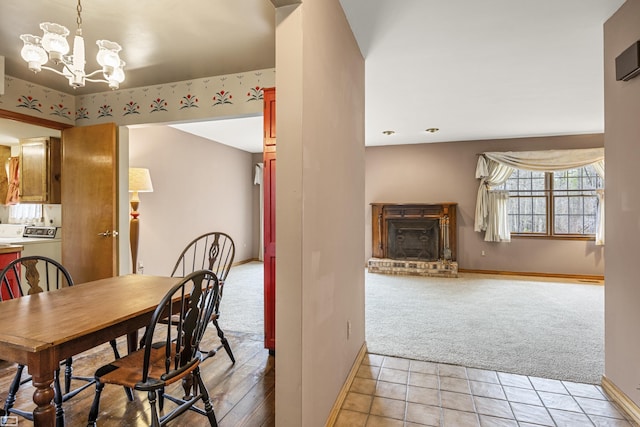 475 S Bartlett Rd, Saint Clair, MI 48079 - dining space featuring a notable chandelier, baseboards, light carpet, and washer / clothes dryer
