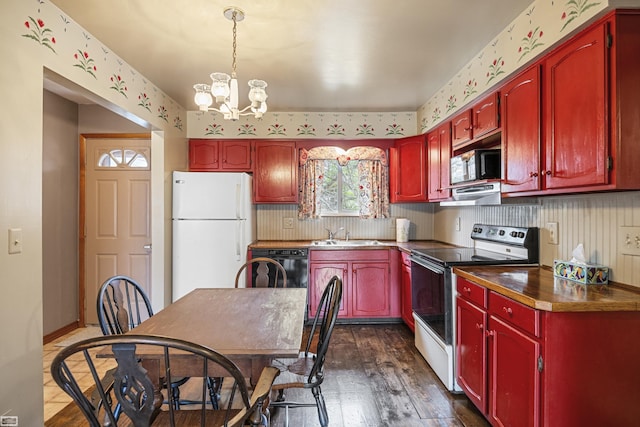 475 S Bartlett Rd, Saint Clair, MI 48079 - kitchen with dark wood-style floors, dark brown cabinets, freestanding refrigerator, a chandelier, and electric stove