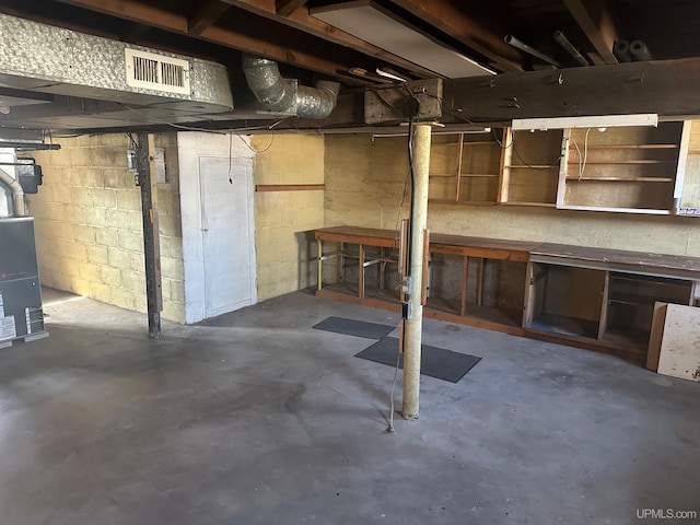 unfinished below grade area featuring visible vents and a workshop area