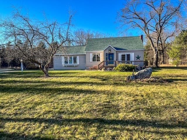 single story home featuring a front yard and a deck