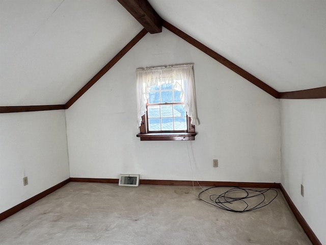 bonus room with light colored carpet, lofted ceiling with beams, baseboards, and visible vents