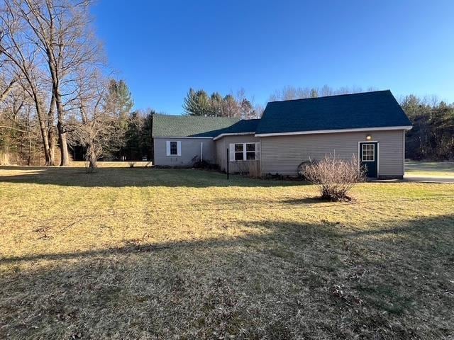 view of side of property with a yard