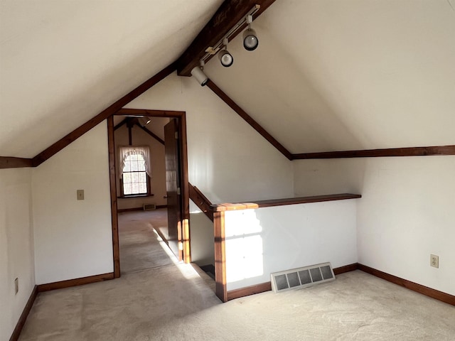 bonus room with lofted ceiling, carpet flooring, visible vents, and baseboards