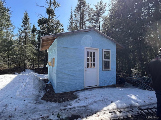 snow covered structure with an outdoor structure