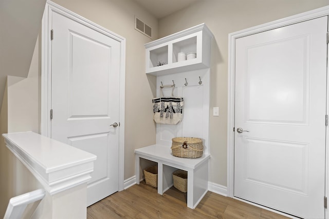 mudroom featuring baseboards, wood finished floors, and visible vents