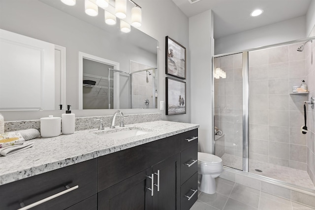 bathroom with vanity, toilet, tile patterned flooring, and a stall shower