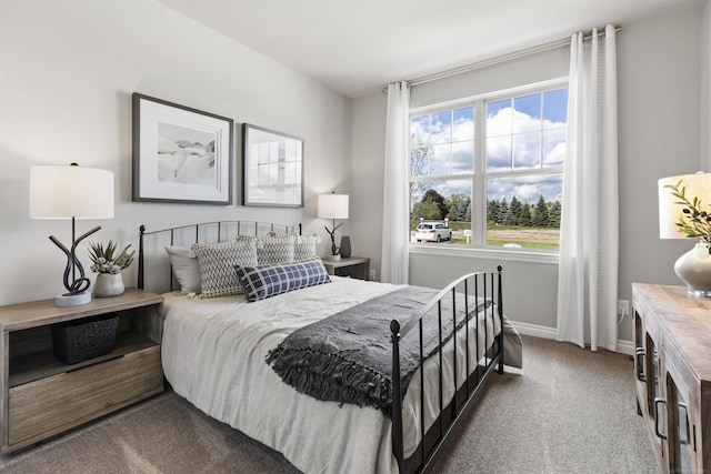 carpeted bedroom featuring baseboards