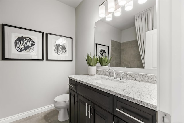 full bath featuring vanity, baseboards, toilet, tile patterned flooring, and tiled shower