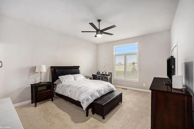 bedroom featuring ceiling fan, baseboards, and light carpet