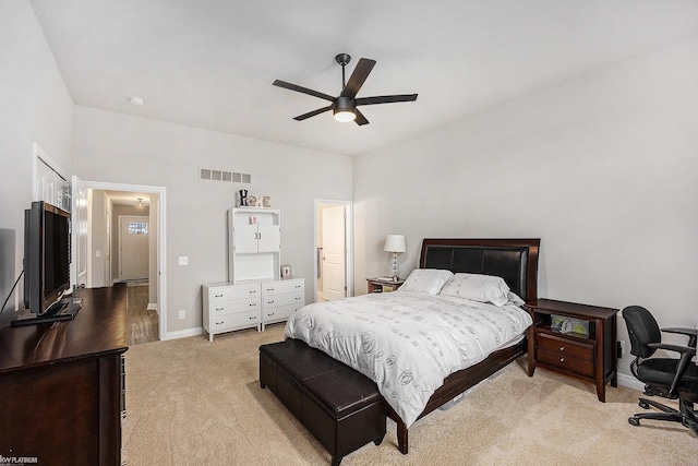 bedroom featuring ceiling fan, light carpet, visible vents, and baseboards