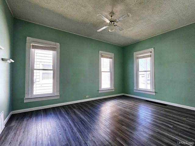 unfurnished room featuring baseboards, a textured ceiling, dark wood-style floors, and ceiling fan