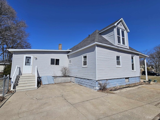 rear view of house featuring a patio and entry steps