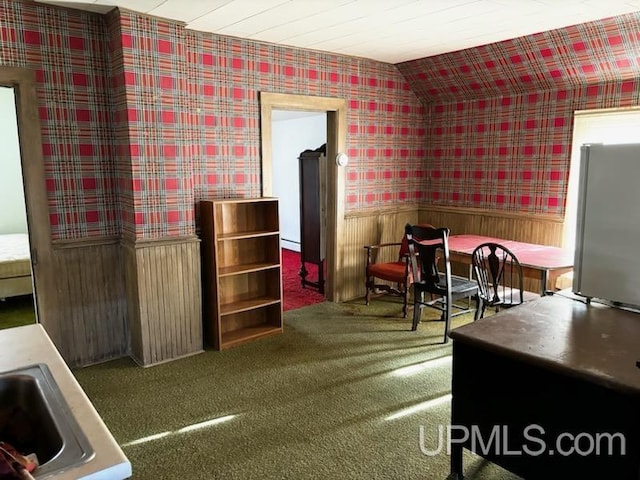 interior space with wallpapered walls, carpet flooring, and wainscoting