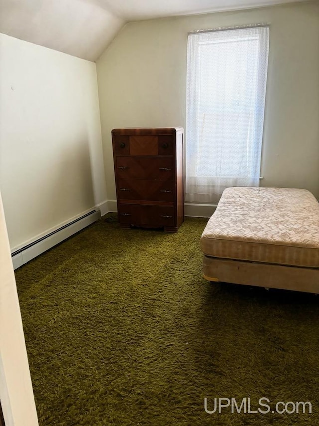 bedroom with lofted ceiling, dark colored carpet, and a baseboard radiator