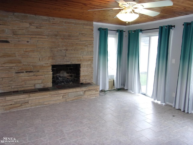 unfurnished living room with a fireplace, wooden ceiling, and ceiling fan