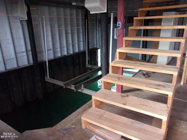 stairway featuring concrete flooring
