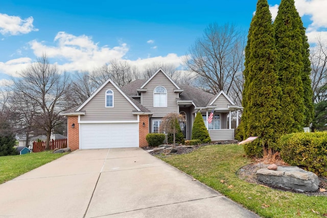 view of front of property featuring a front lawn, brick siding, fence, and driveway
