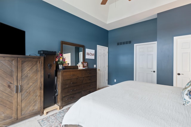 bedroom with ceiling fan, visible vents, and light carpet