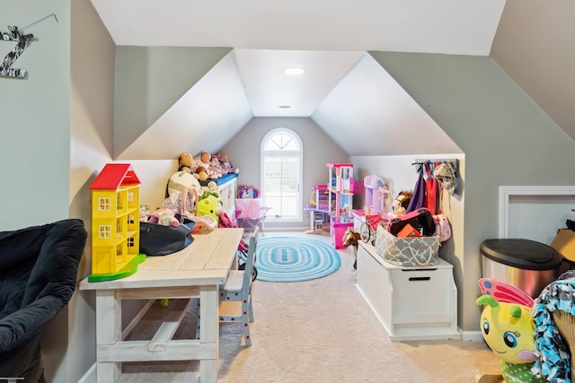 recreation room featuring vaulted ceiling and carpet