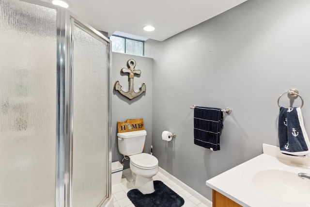 full bathroom with a shower stall, vanity, baseboards, toilet, and tile patterned flooring