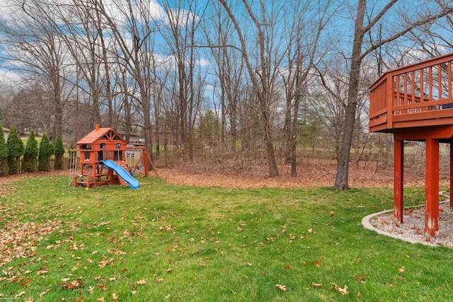 view of yard featuring a deck and a playground