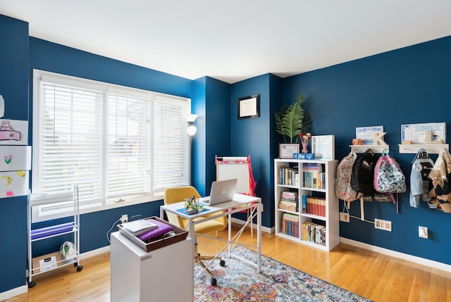 home office featuring plenty of natural light, baseboards, and wood finished floors
